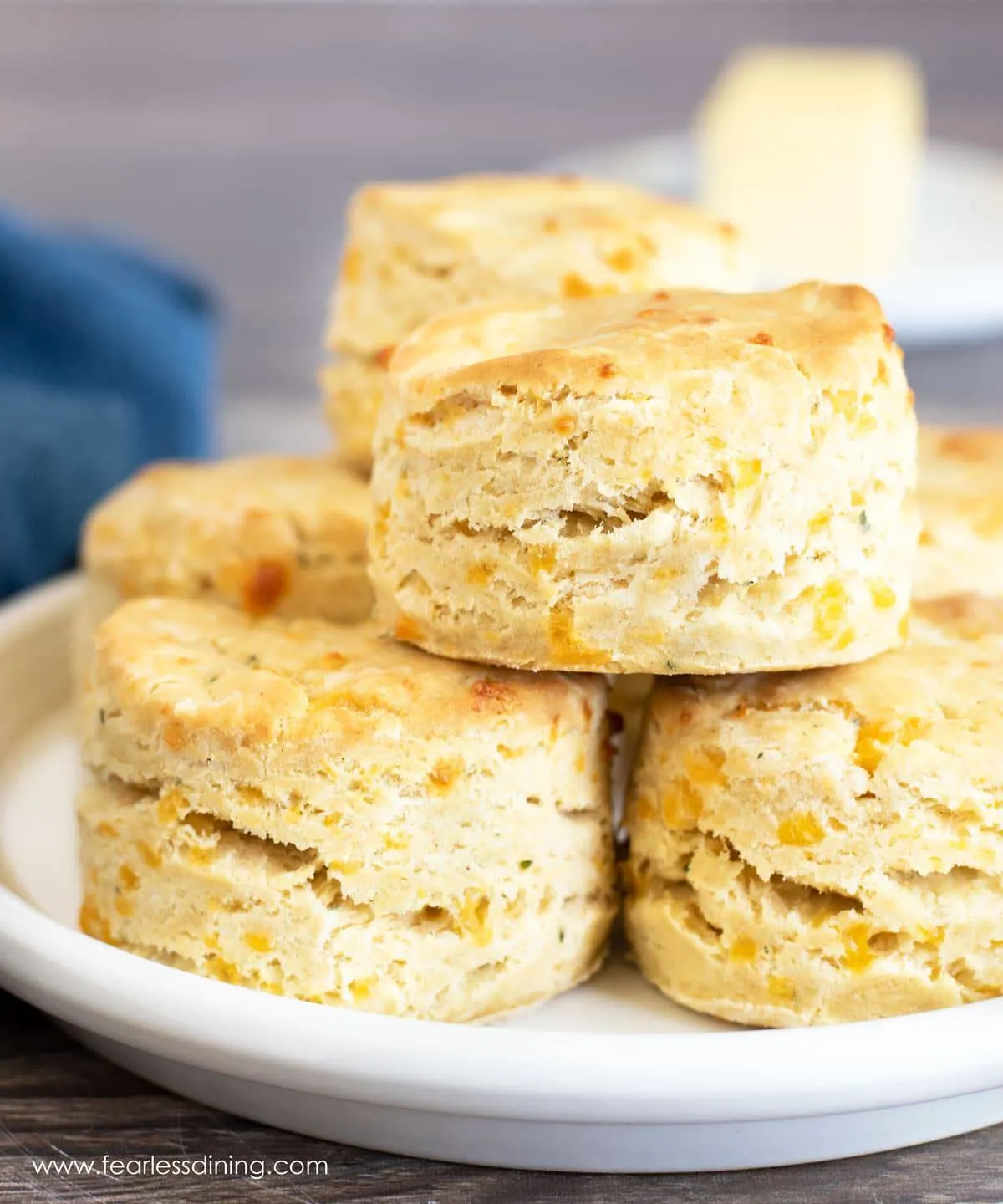 A stack of cheesy biscuits on a white plate.