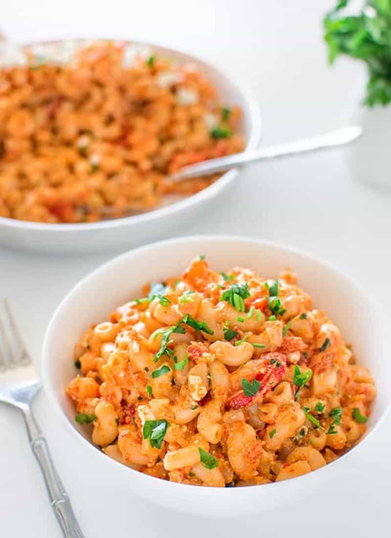 Macaroni with goat cheese and parsley garnish.