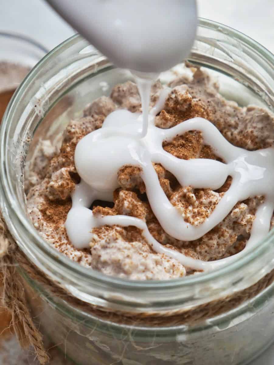 Cinnamon roll overnight oats with Greek yogurt in a jar.