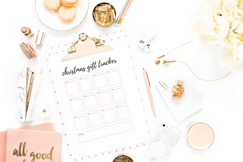 Christmas gift tracker and pink and gold planner in white background.