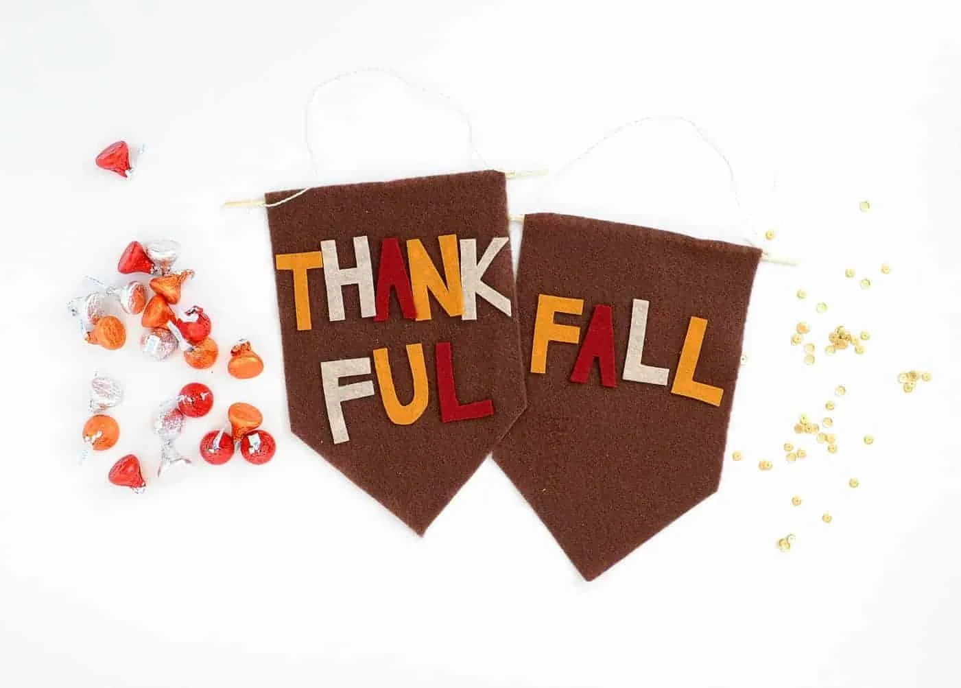 Thankful Fall banner next to orange and red candies.