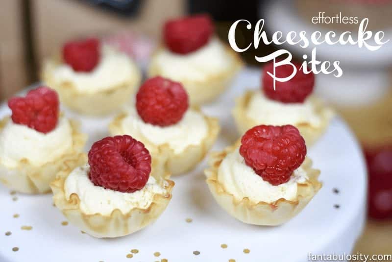 Cheesecake bites with raspberry topping on a white plate.