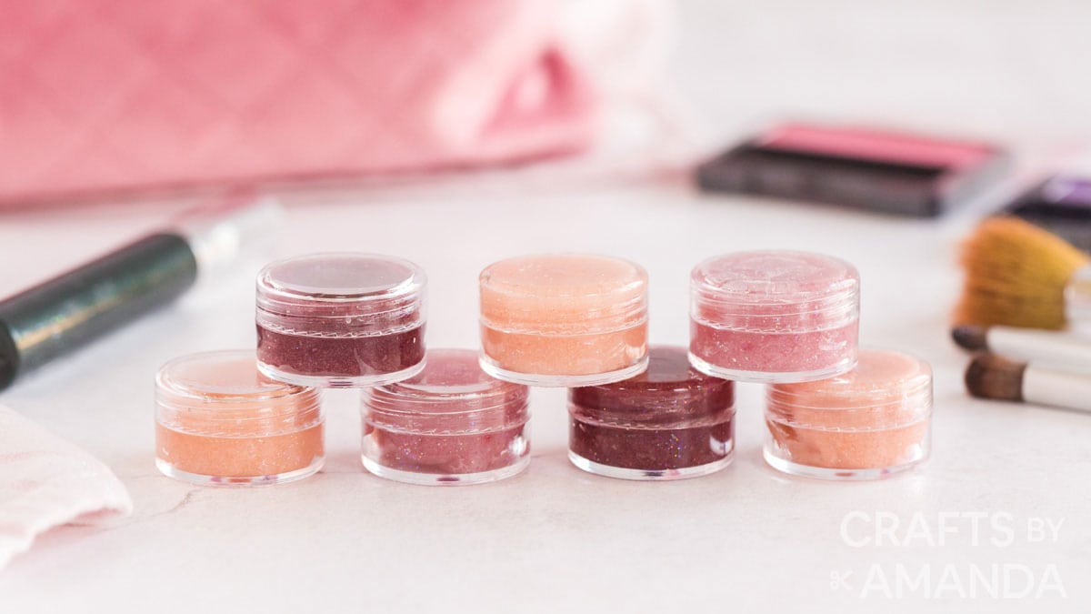 Peach, red and pink lip gloss in small round containers.