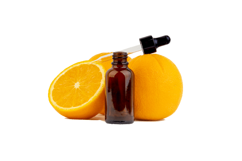 A serum bottle with dropper and oranges in the background.
