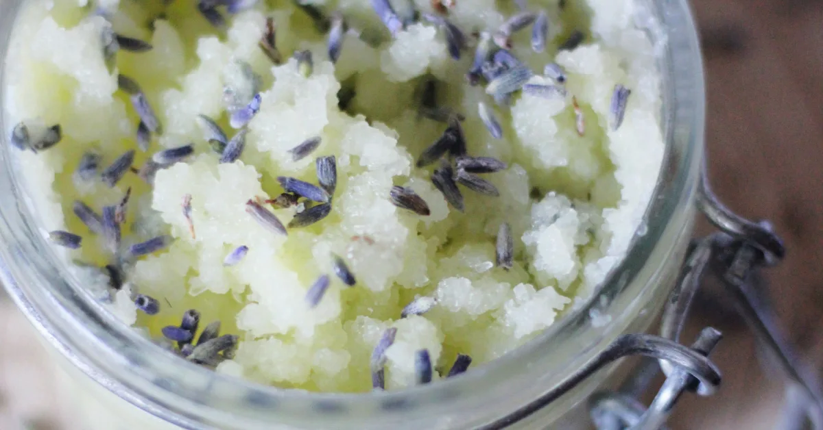 Close up photo on epsom salt scrub with lavender flowers in an open jar.