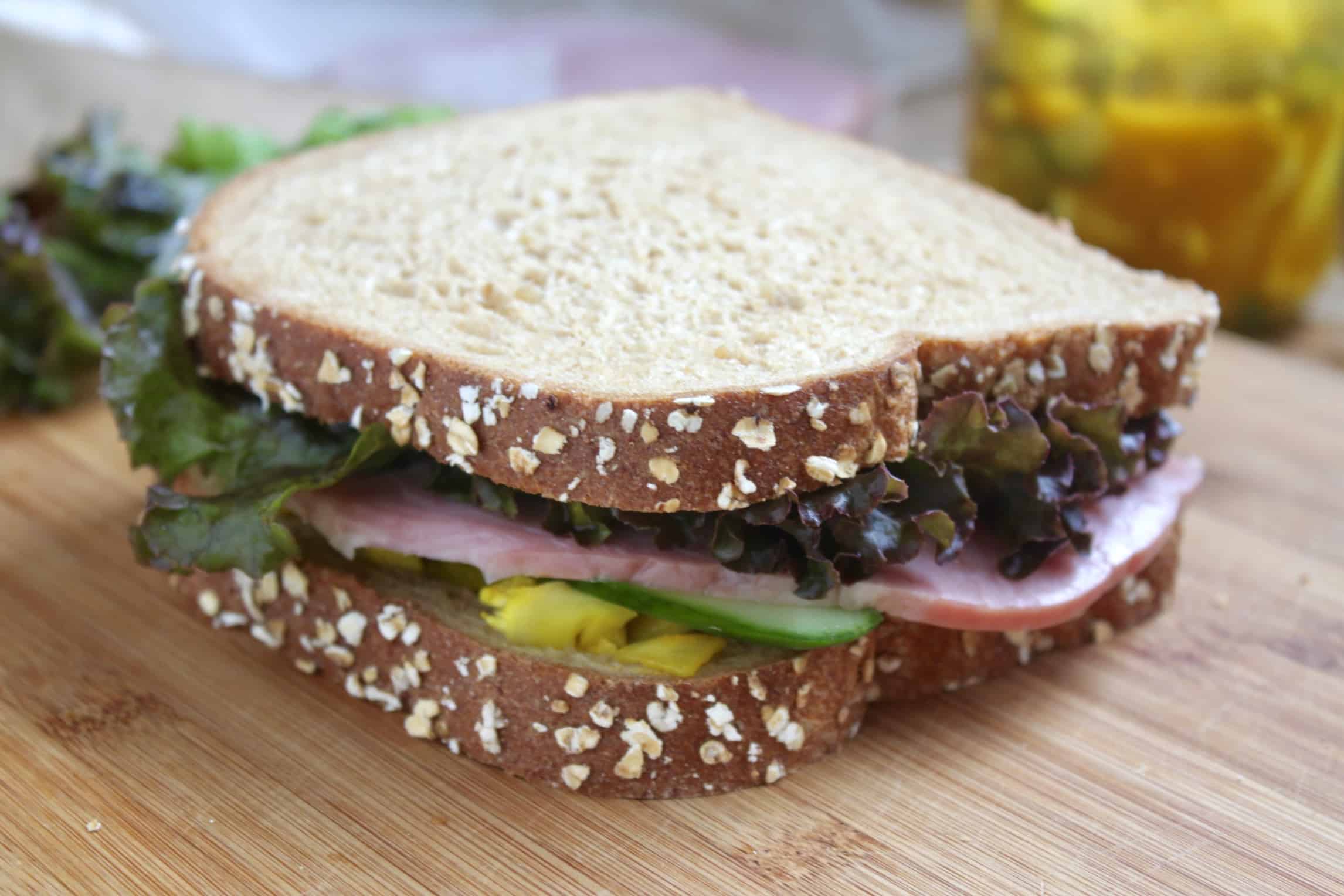 Ham cucumber lunch sandwich on wheat bread.