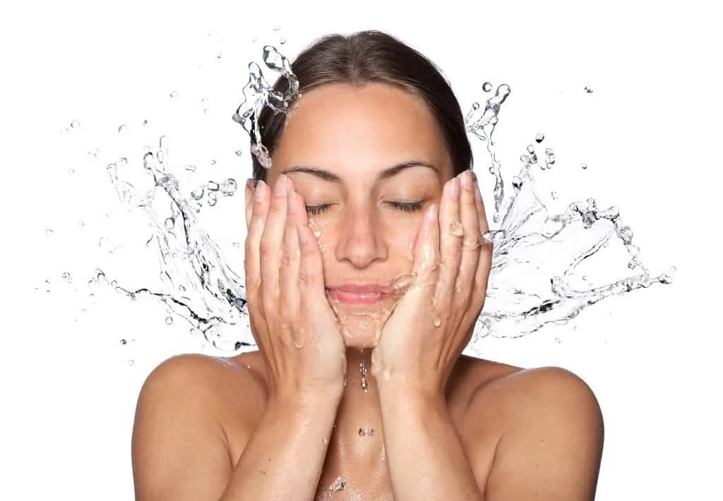 A woman washing her face with clean water.