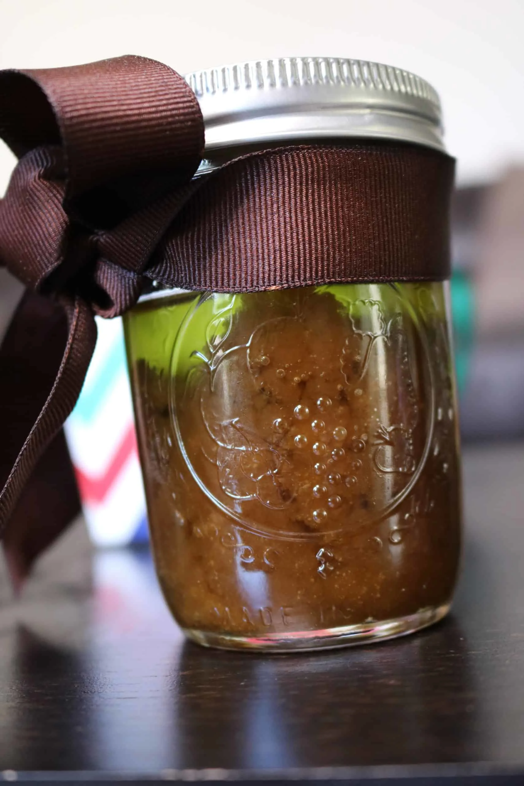 Brown sugar scrub in a gift jar with brown ribbon.