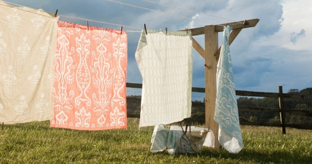 Yellow, red and blue laundry hanging on the clothes line under the sun.