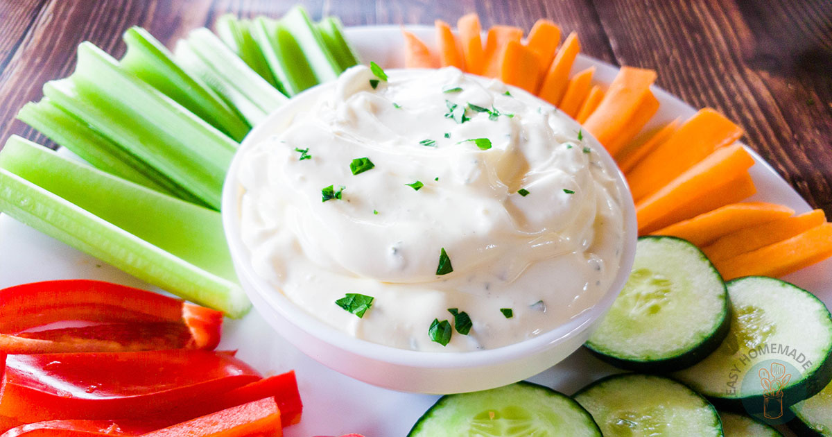 3-ingredient easy onion dip in the middle of a plate full of freshly sliced vegetables.