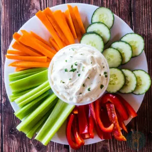3-ingredient easy onion dip with fresh vegetables on a plate.
