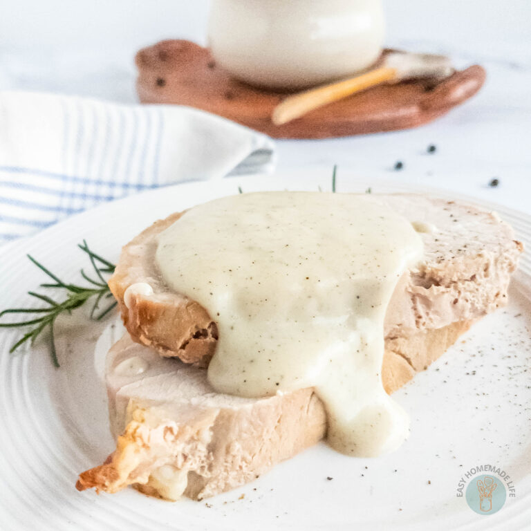 Pepper gravy on pork chops. A white soup bowl at the background.