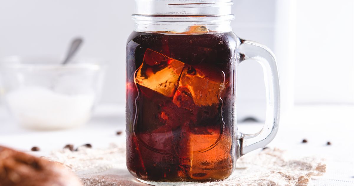 Cold brew coffee in glass mug with ice cubes.