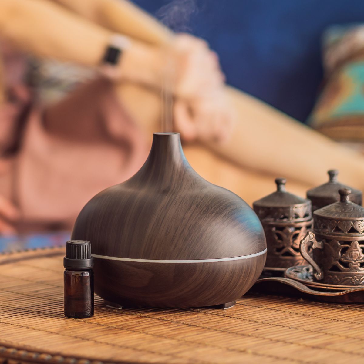 An essential oil diffuser on a wooden table.