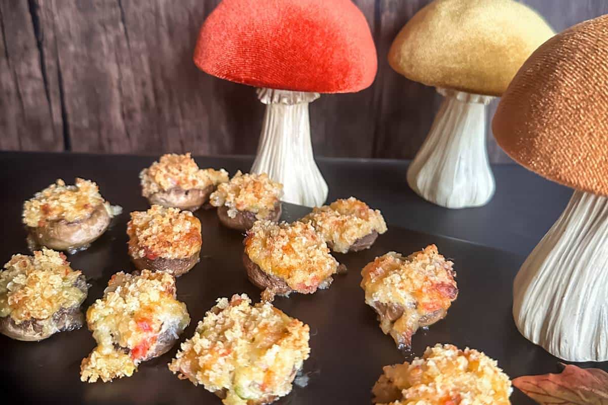 Stuffed mushrooms on a black plate.