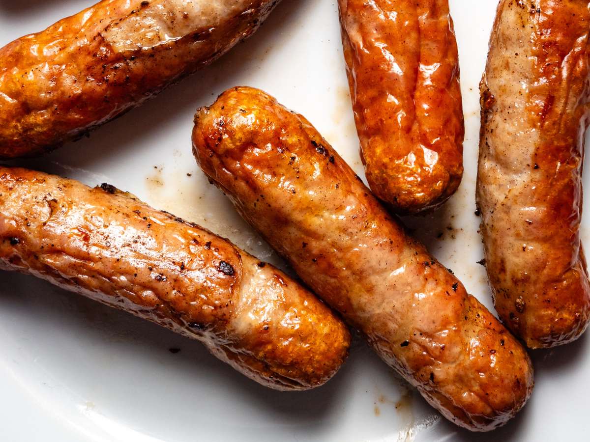 Sausages on a plate on a white plate.