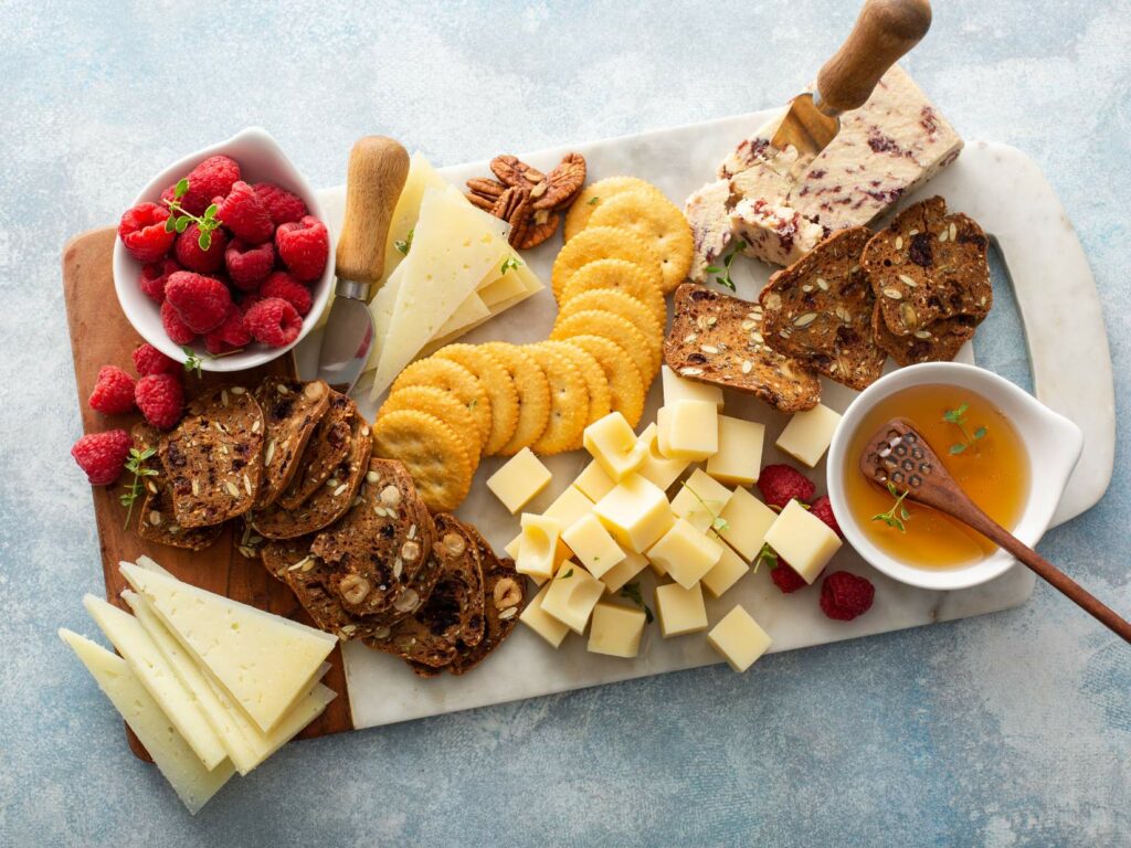 A charcuterie board with an assortment of food.