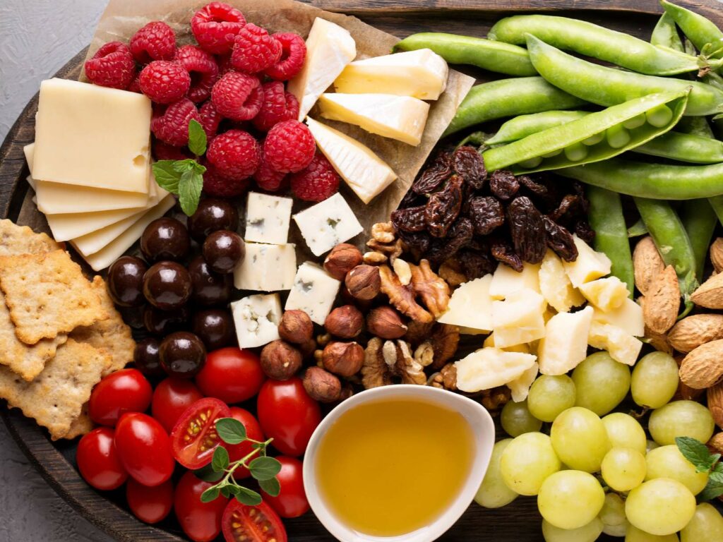 A wooden platter containing a variety of fresh food.