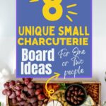 Top view of a small charcuterie board with assorted cheeses, grapes, nuts, and bread. Text above the board reads, "8 Unique Small Charcuterie Board Ideas for One or Two People.