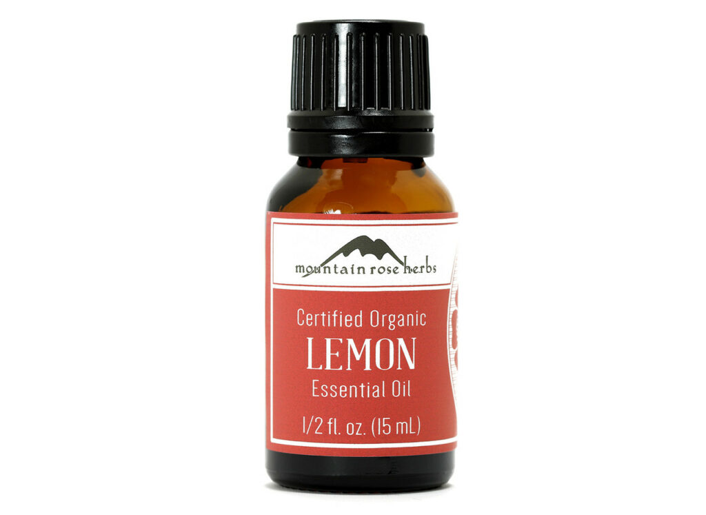 A 15mL amber glass bottle labeled "Certified Organic Lemon Essential Oil" by Mountain Rose Herbs, featuring a black screw cap and a red and white label—perfect for an easy homemade life.