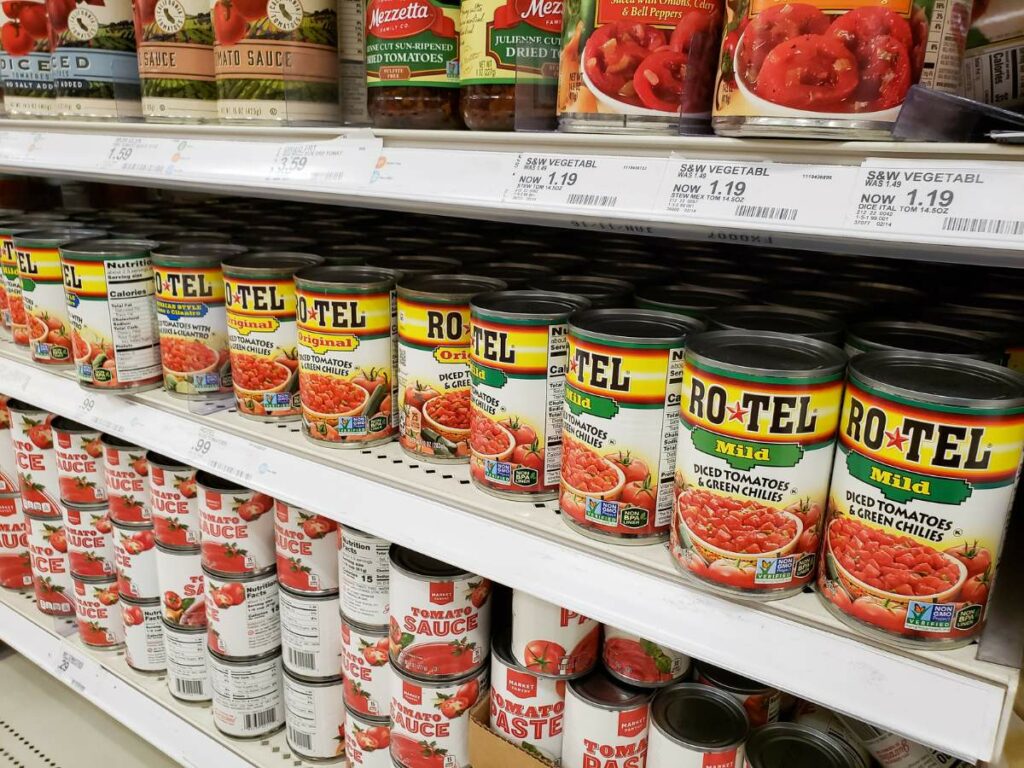 Shelves stocked with various brands and types of diced tomatoes and sauces.