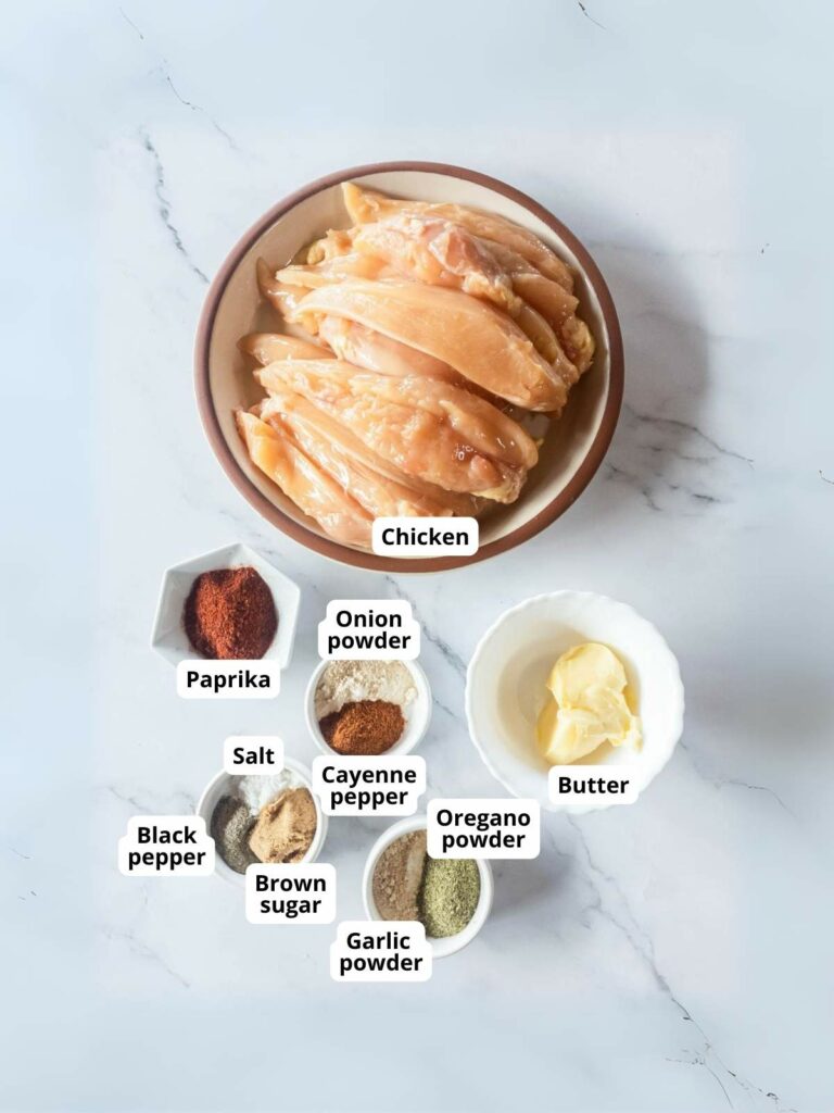 Laid out ingredients of popeyes blackened chicken tenders on a marble surface.