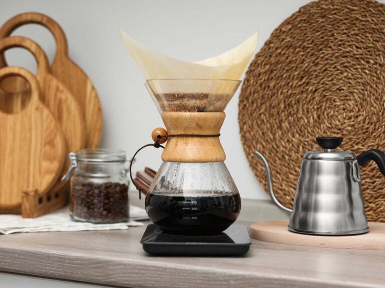 A pour-over coffee maker with freshly brewed coffee sits on a kitchen countertop.