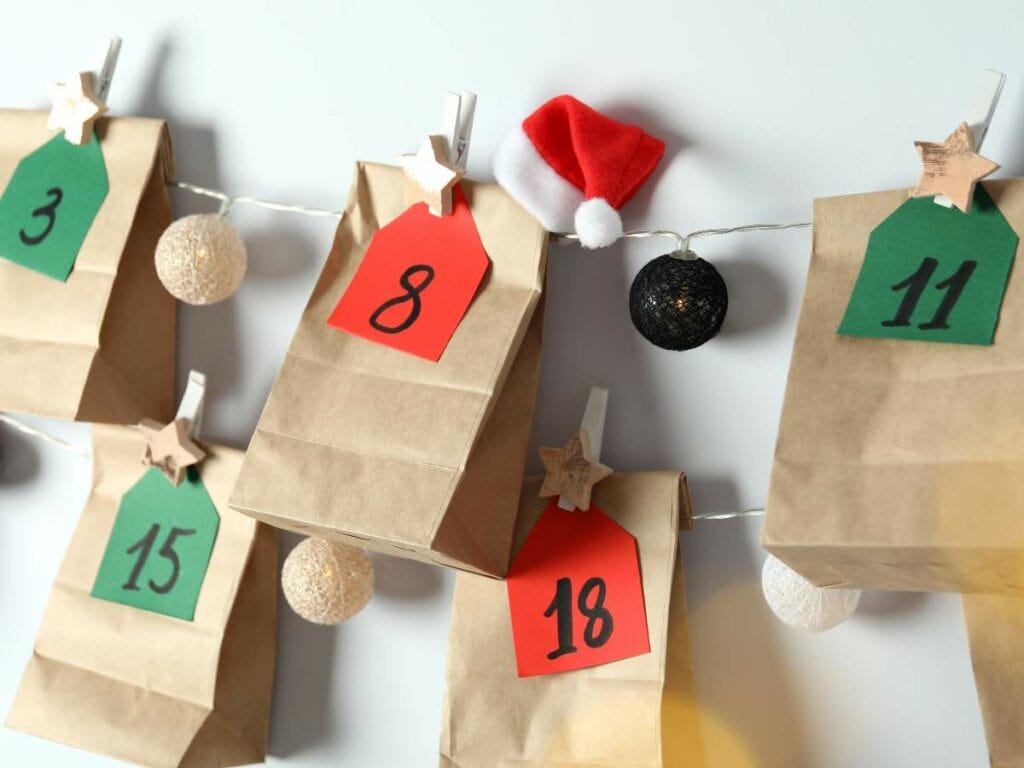 Brown paper bags with numbered tags hang on a string.