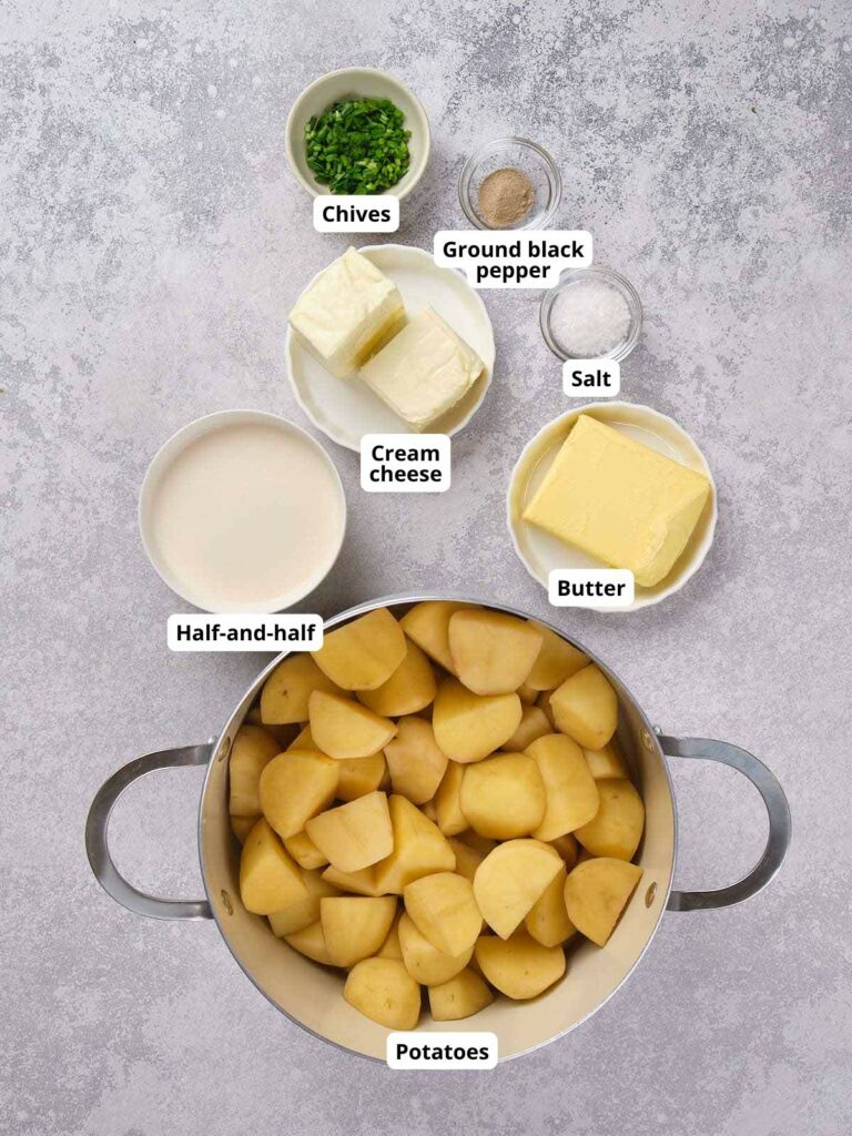 Ingredients for mashed potatoes on a gray surface.