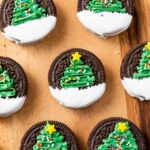 Christmas tree oreos placed on a wooden surface.