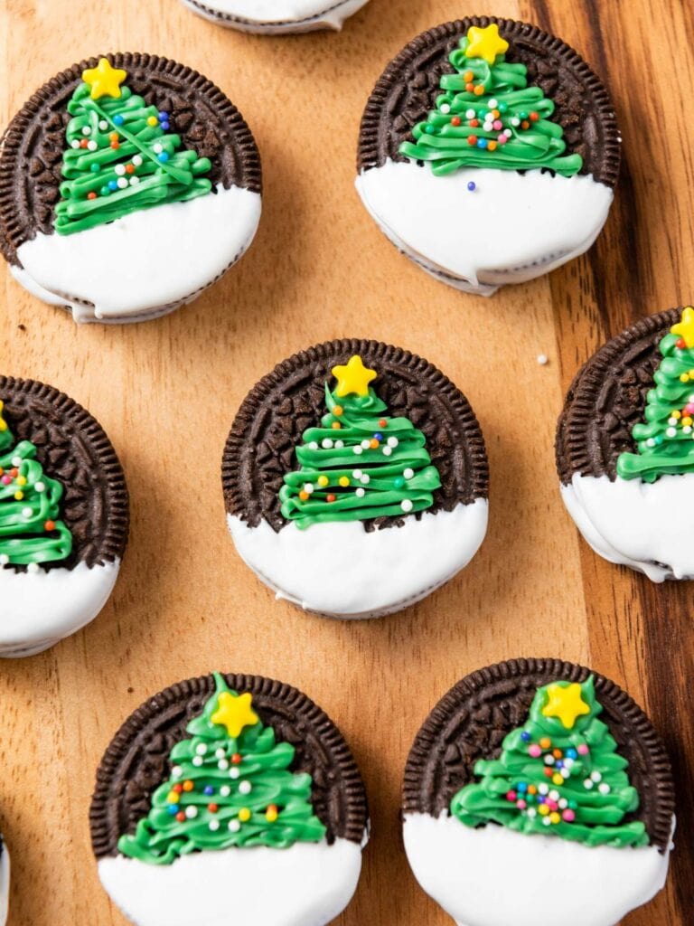 Christmas tree oreos placed on a wooden surface.