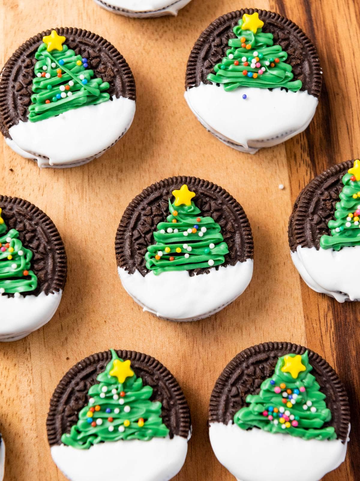 Christmas tree oreos placed on a wooden surface.