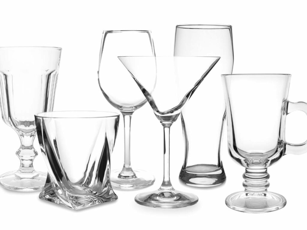 Various types of empty glassware including wine, martini, and beer glasses.