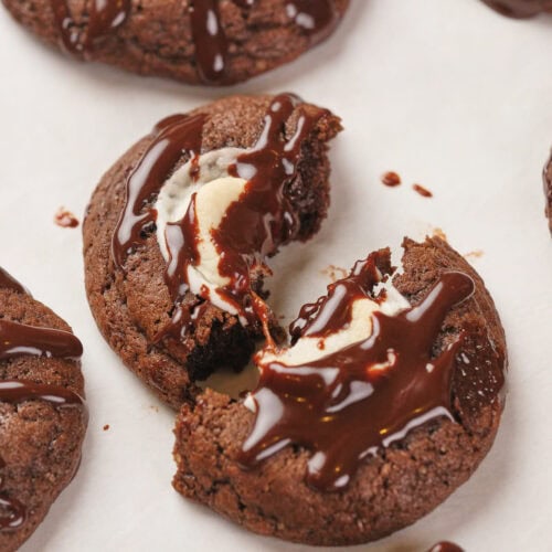 Chocolate cookies topped with marshmallows, drizzled with melted chocolate.