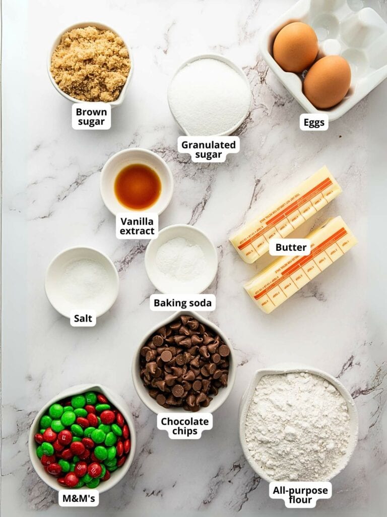 Baking ingredients for m&m cookies on a marble surface.