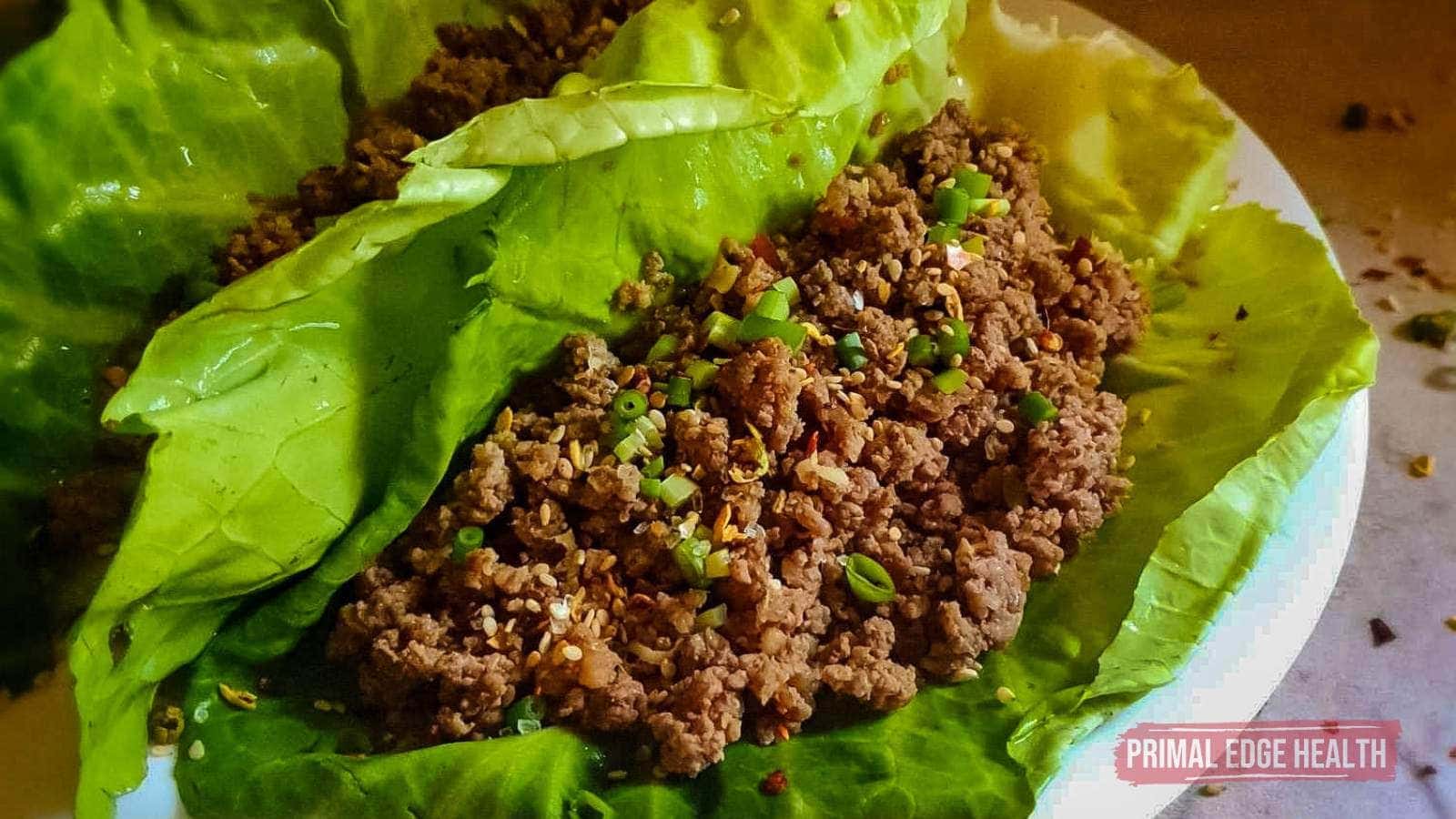 Korean Ground Beef in lettuce wrap on white plate.