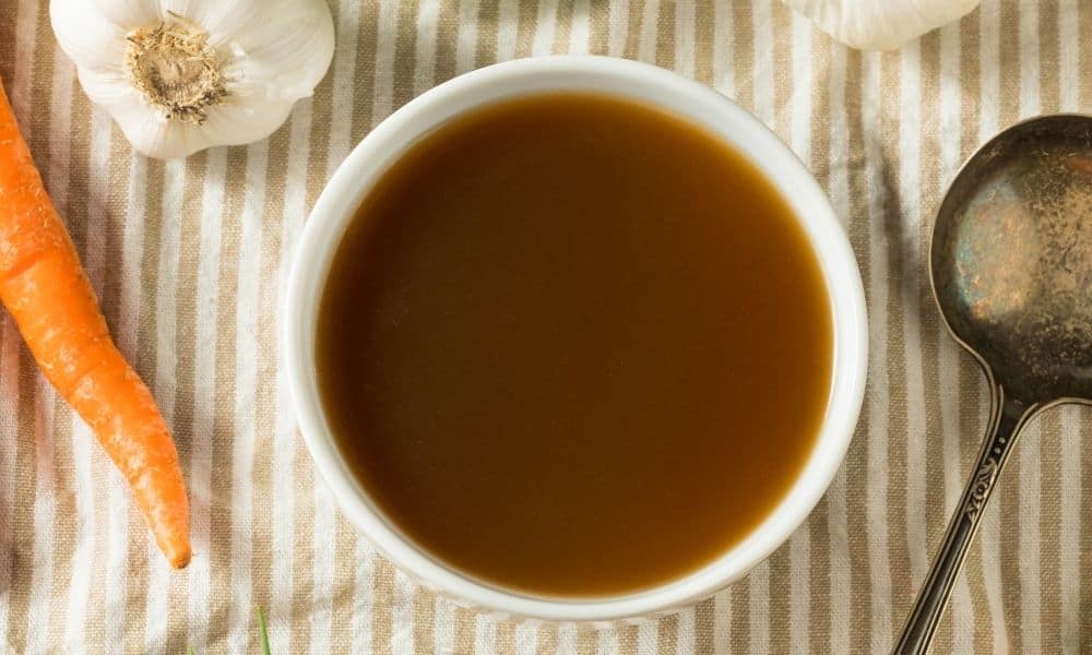 Homemade Beef Bone Broth in white bowl.