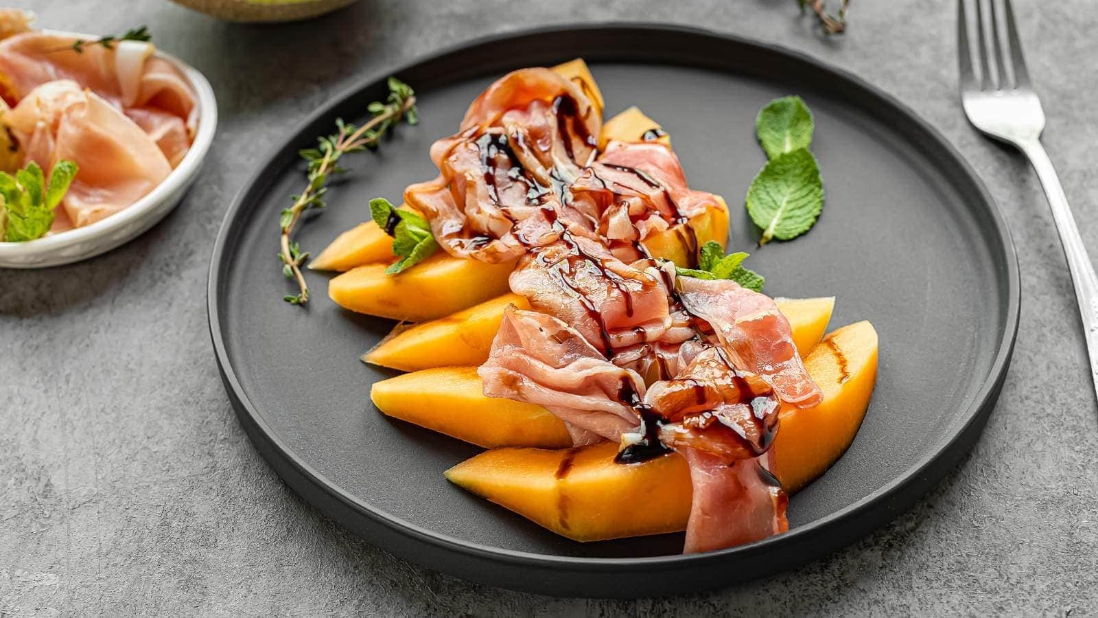 Balsamic glaze on prosciutto and melon.