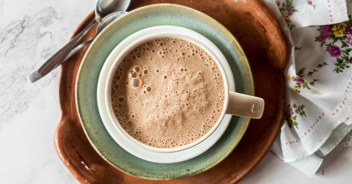 A picture of bone broth coffee late in white mug with overhead view.