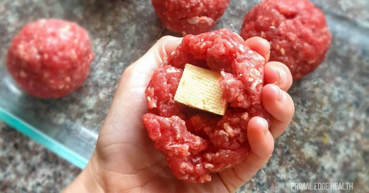 Meatballs with cheese on a plate.