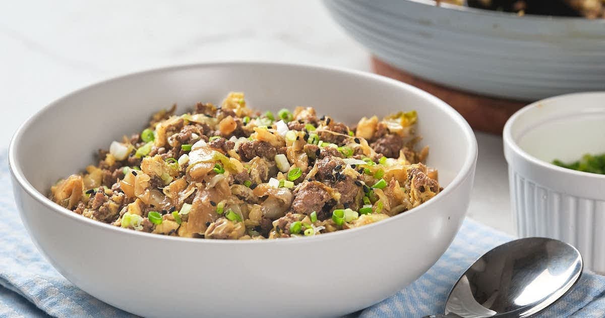 A white bowl filled with egg roll in a bowl.