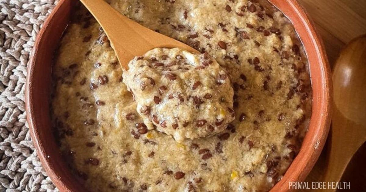 Hot cereal in a bowl with a wooden spoon.