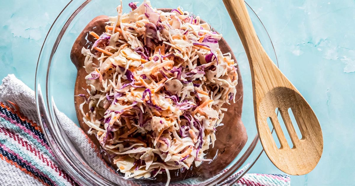 A picture of low-carb coleslaw recipe with creamy dressing in glass bowl.