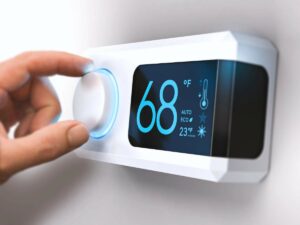 Hand adjusting a modern digital thermostat set to 68°F, displaying temperature and eco mode settings on a screen.